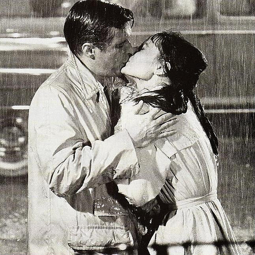 young couple kissing in rain. rain. young couple kissing